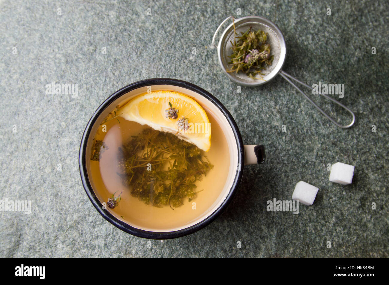Wild thyme herbal tea with lemon in a cup Stock Photo