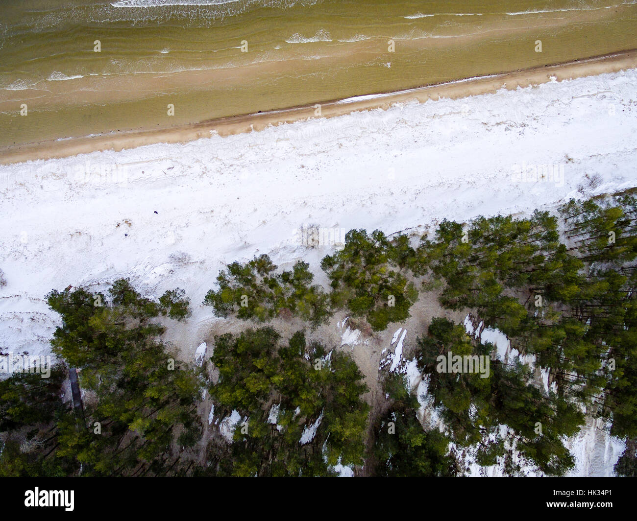 aerial view of frozen forest lake in winter. drone photography ...