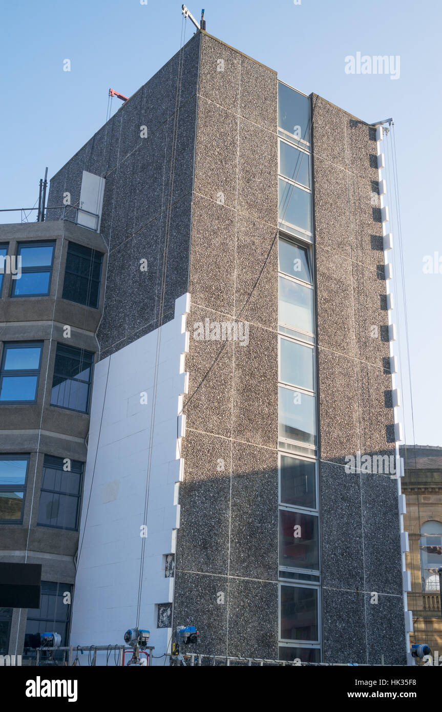 Conversion of old office building Aidan House into flats with external insulating cladding being applied, Newcastle north east England UK Stock Photo