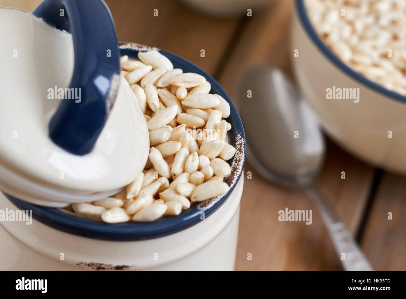 Puffed rice cereal in rustic jar on wooden background Stock Photo