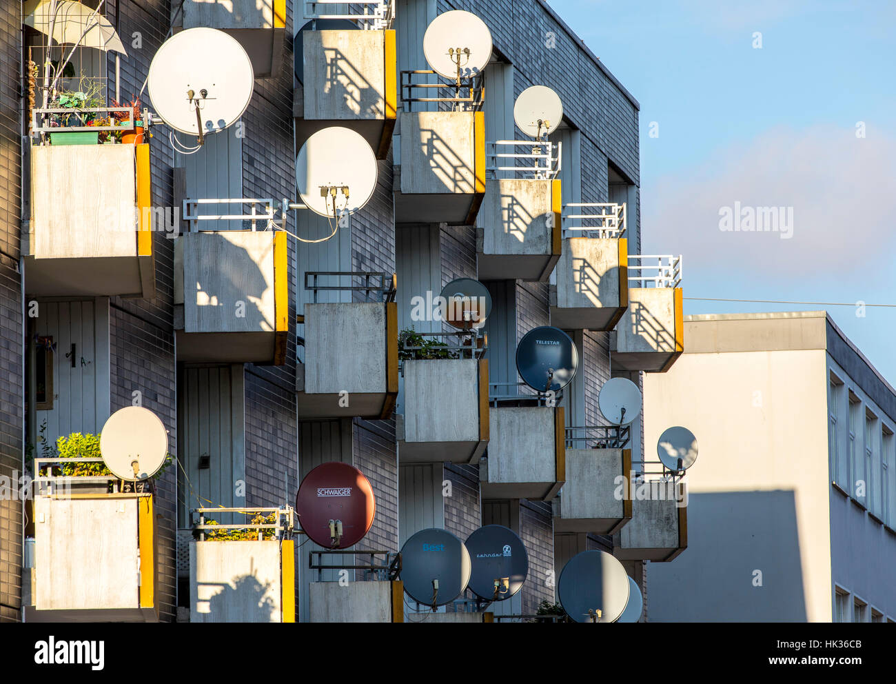 Many TV satellite antennas at a residential house, for TV reception, satellite TV Stock Photo