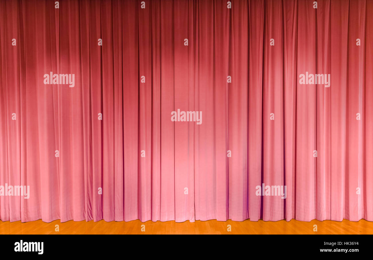 A curtain in pink color, covering a theater stage Stock Photo