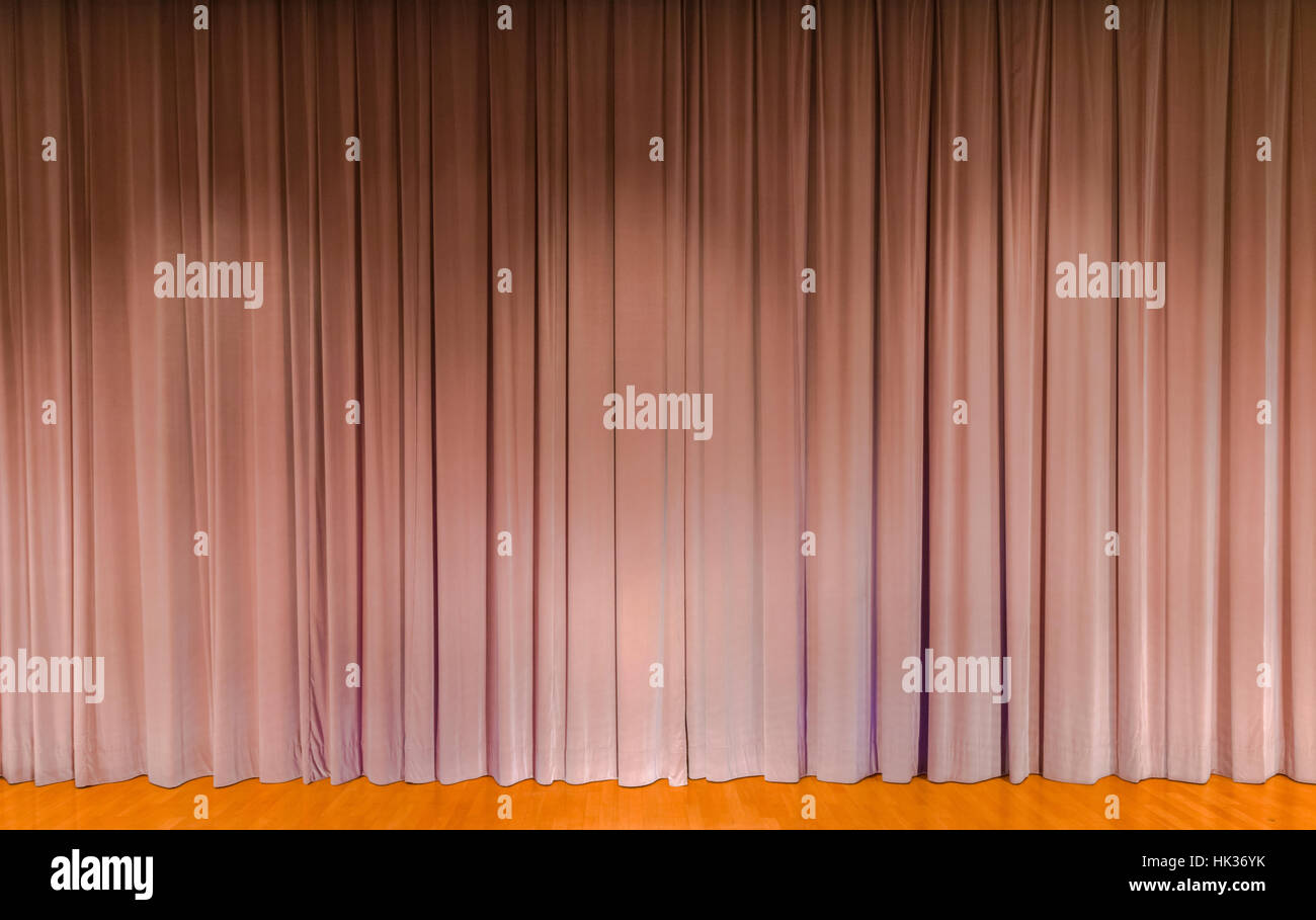 A curtain in beige color, covering a theater stage Stock Photo