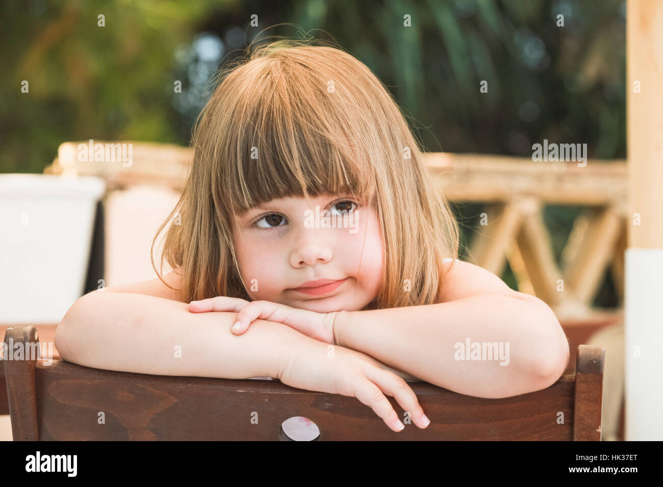 Cute serious Caucasian little girl, close-up outdoor portrait Stock Photo