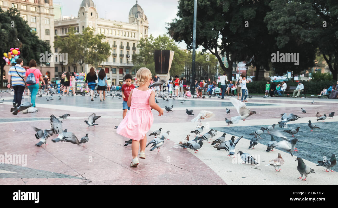 Barcelona, Spain - August 25, 2014: Ordinary people and doves are on placa de Catalunya in Barcelona Stock Photo