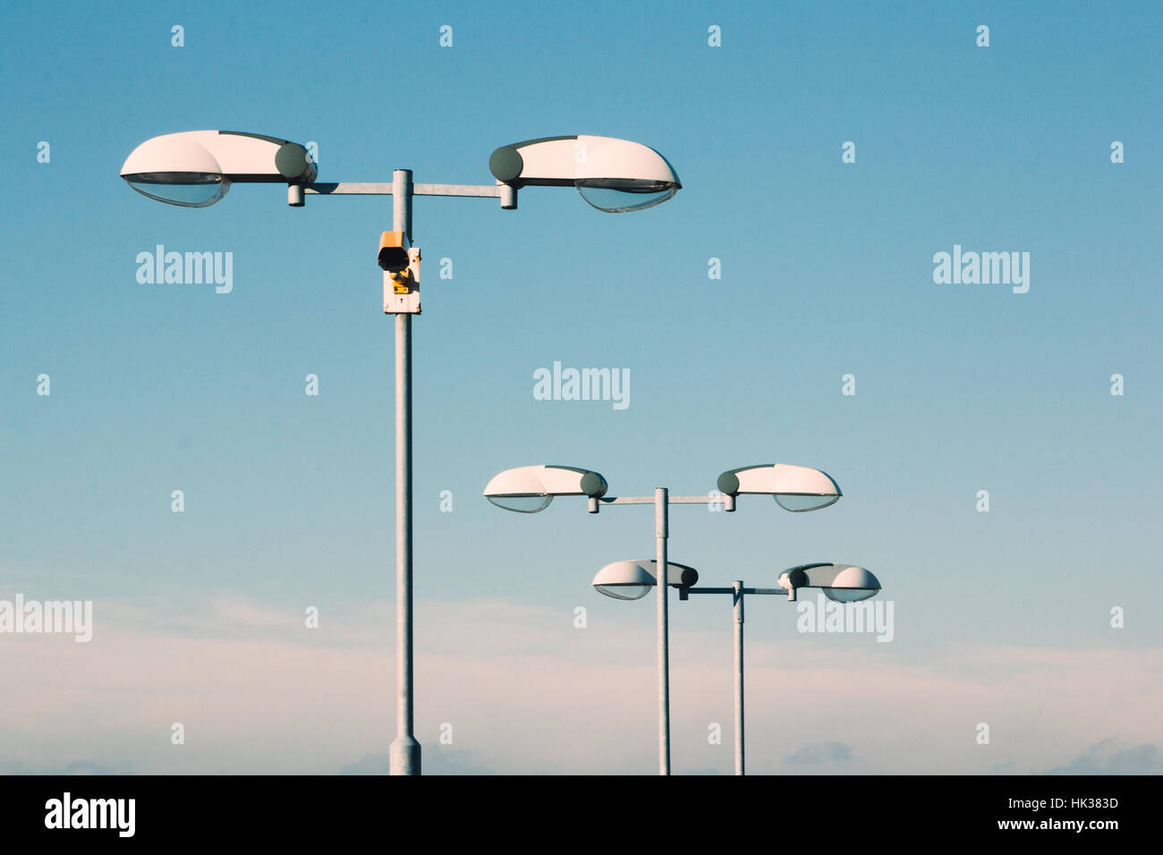 White street lamps against a blue sky in a sunny day Stock Photo