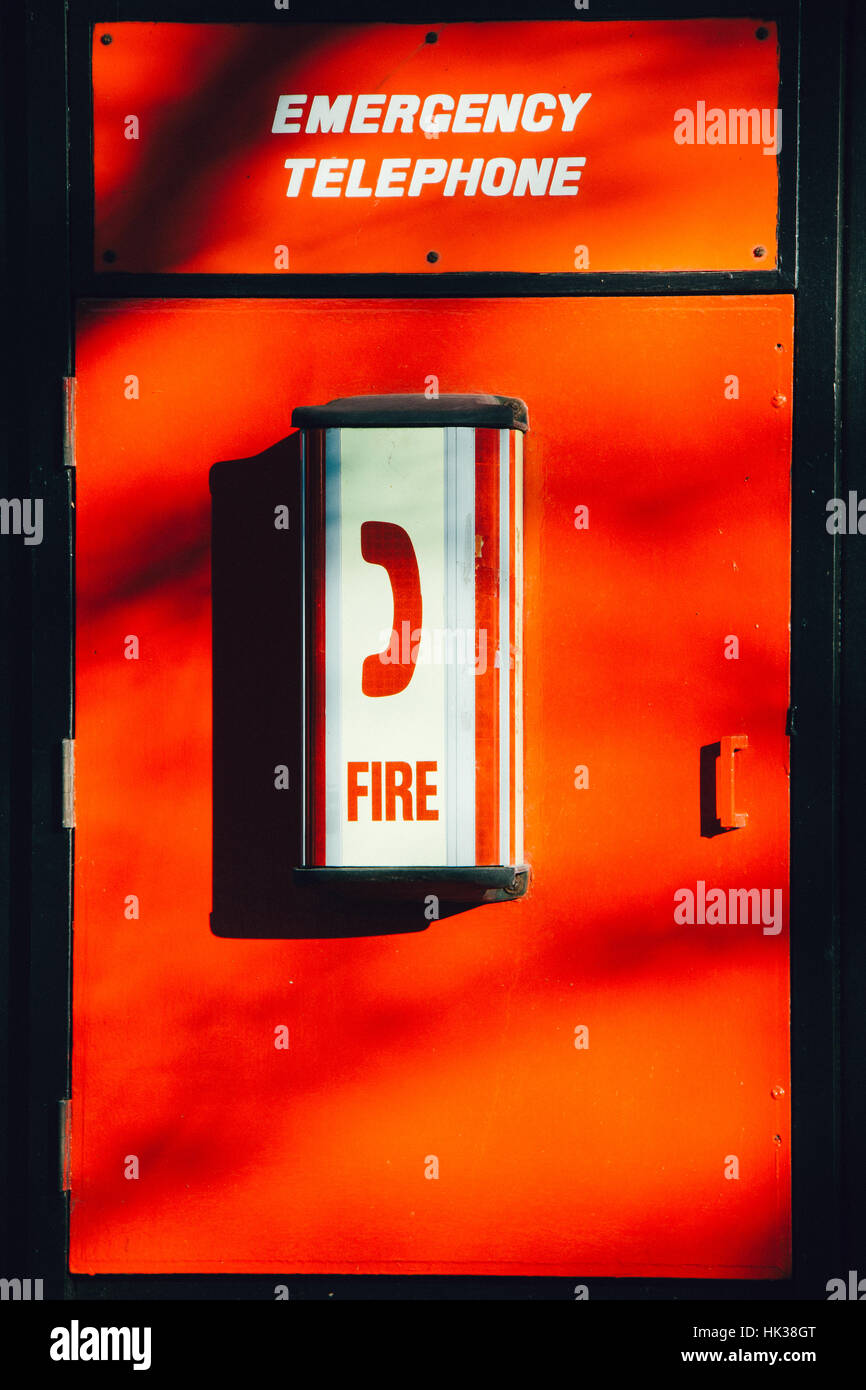 Emergency Telephone with a red background Stock Photo