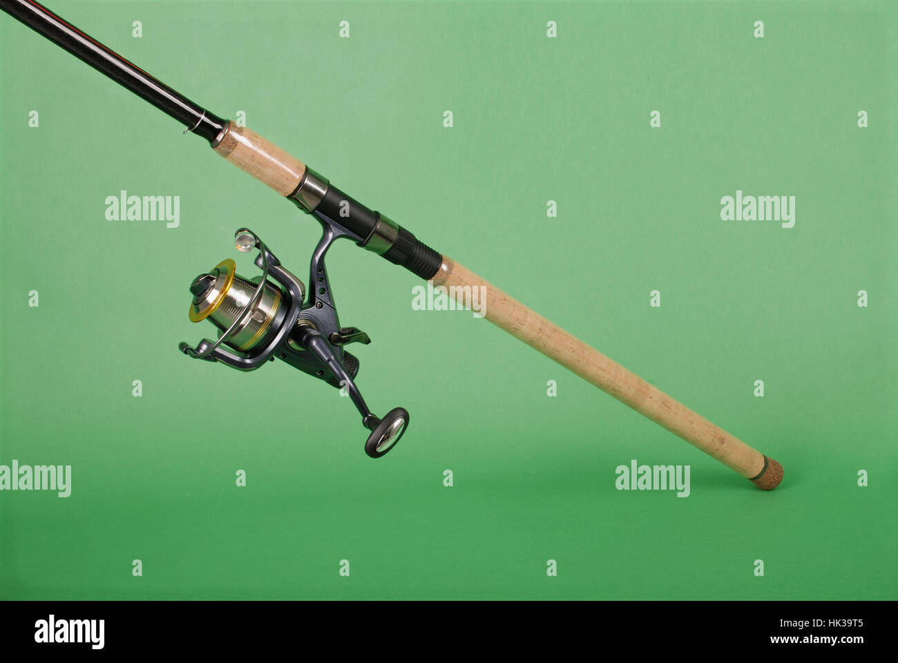 Fishing rod on green background with soft shadow Stock Photo - Alamy