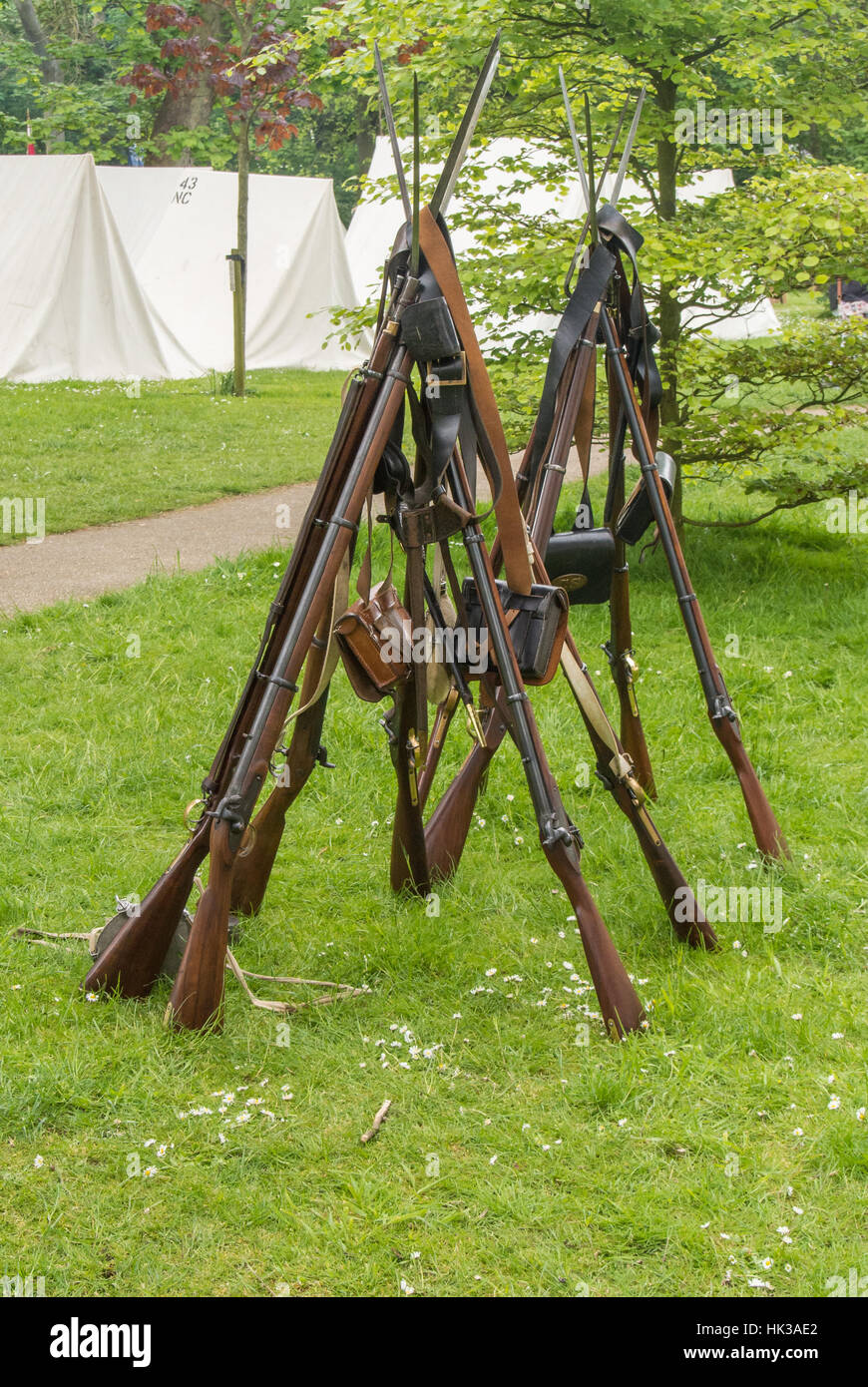 muskets with bayonets stacked in a pyramid at a reenactment of the America civil war Stock Photo