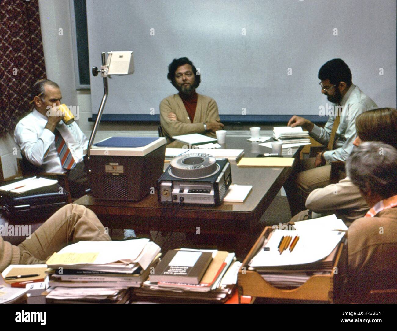 This photograph was taken somewhere in the U.S. during a debriefing held by the Ebola task force after the Zaire outbreak of 1976, 1974. Among the members identified are Centers for Disease Control (CDC) staff, Dr. Karl M. Johnson, (center) and Dr. Joel Breman (right). The Ebola outbreak in Zaire, now known as the Democratic Republic of Congo, started in the town of Yambuku, and from there spread to surrounding areas. A Kinshasa area hospital was sealed off during the outbreak, helping to bring the situation under control. The total number of cases in Zaire was 318 and had a mortality rate of  Stock Photo