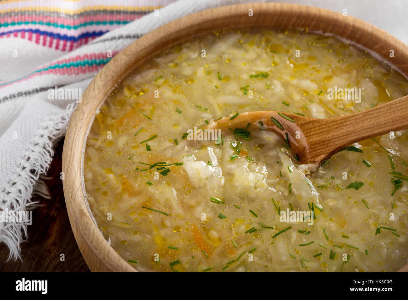 Ukrainian sauerkraut soup kapusniak with millet on rustic table in