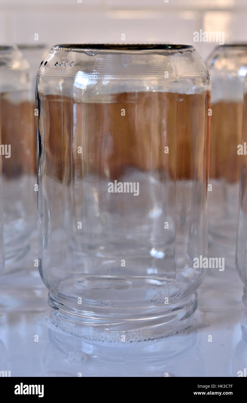 Empty glass jar upside down on draining board Stock Photo