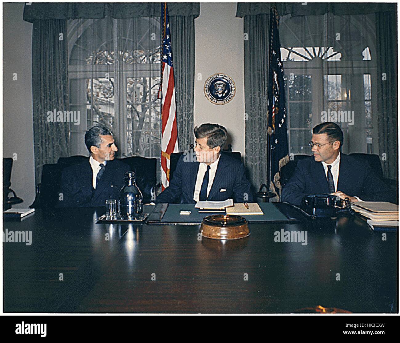 United States President John F. Kennedy meets the Shah of Iran, Mohammad Reza Shah Pahlavi, in the Cabinet Room at the White House on April 13, 1962. Left to right: Shah Pahlavi, President Kennedy, U.S. Secretary of Defense Robert McNamara..Credit: Robert Stock Photo