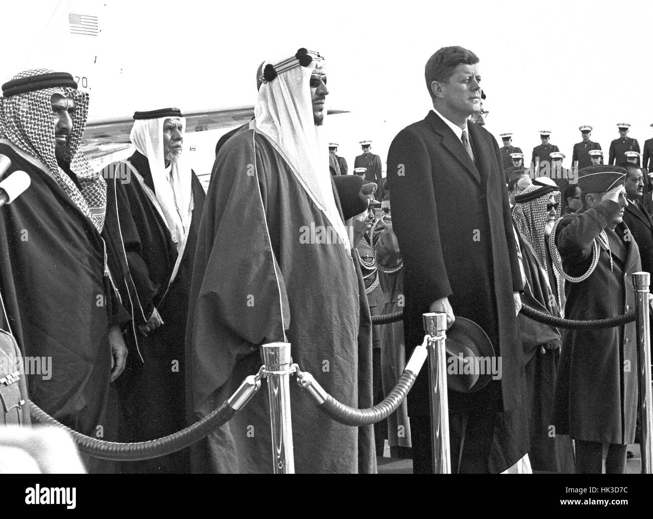 King Saud bin Abdulaziz Al Saud of Saudi Arabia makes remarks as he is welcomed to the United States by US President John F. Kennedy during a ceremony at Andrews Air Force Base, Maryland on February 13, 1962. From left to right: unidentified, President Ke Stock Photo