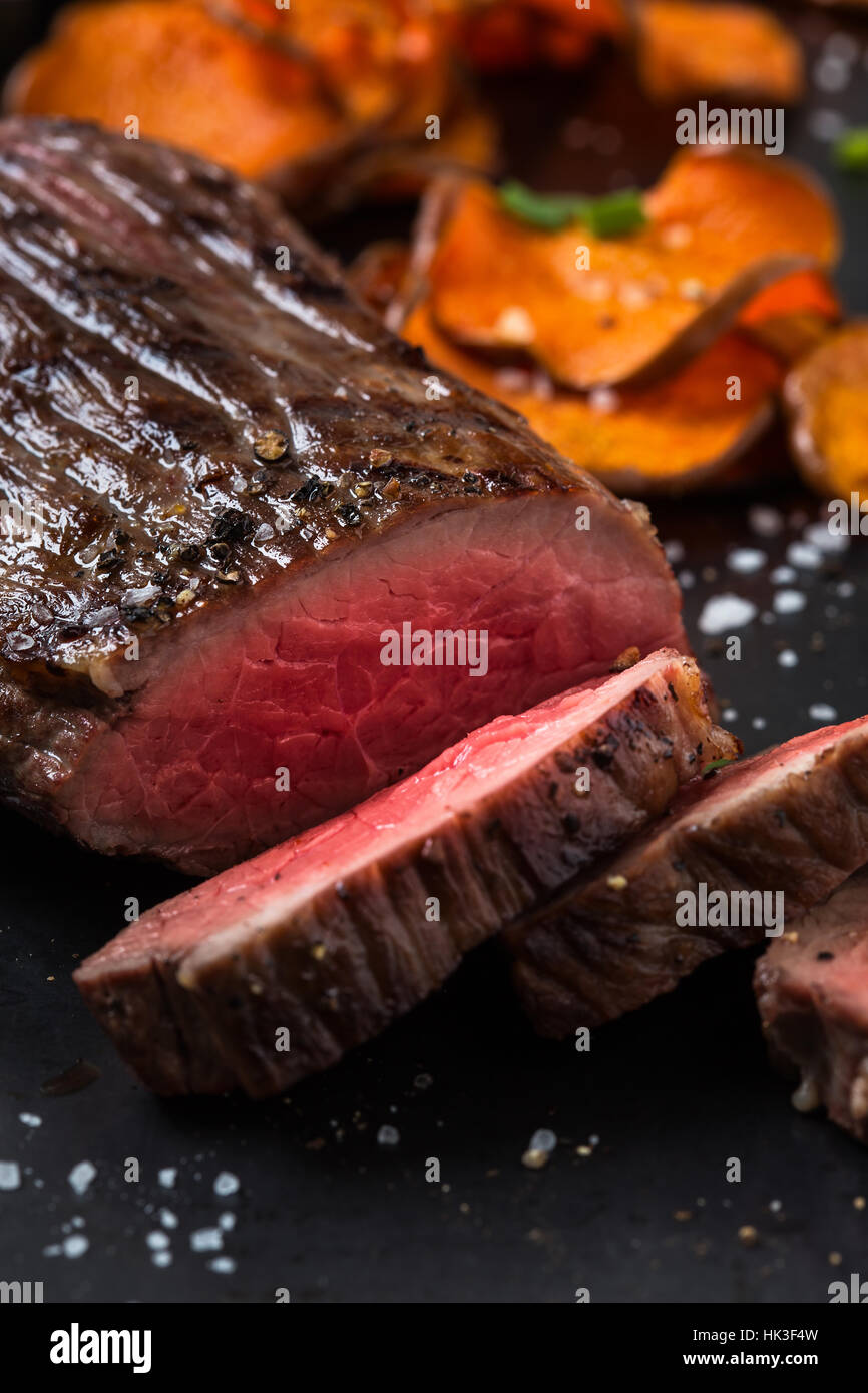 Rare roast beef sirloin with french fries on cutting board Stock Photo Alamy