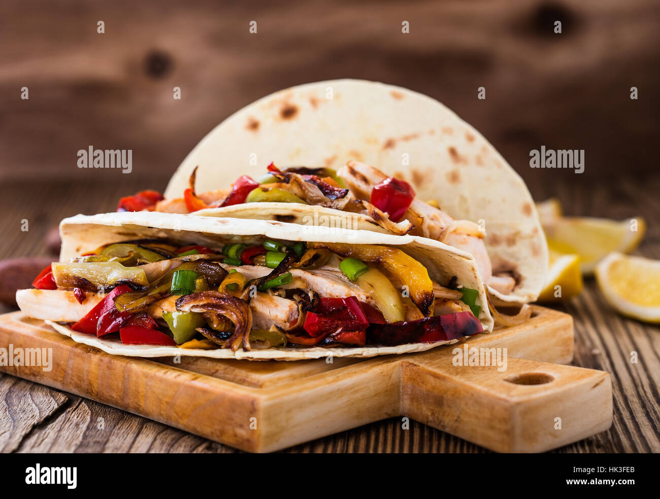 Chicken fajitas with grilled onions and bell peppers and serve with