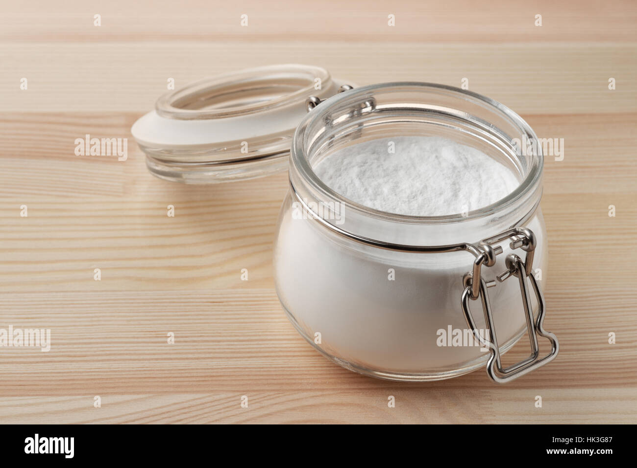 Open glass jar of baking soda on wooden background Stock Photo Alamy