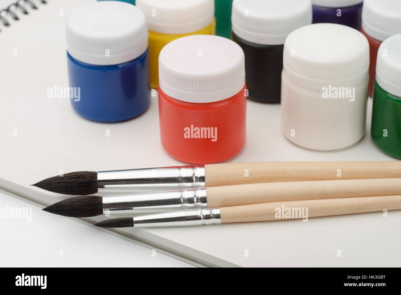 Set of acrylic paints, brushes and sketchbook Stock Photo