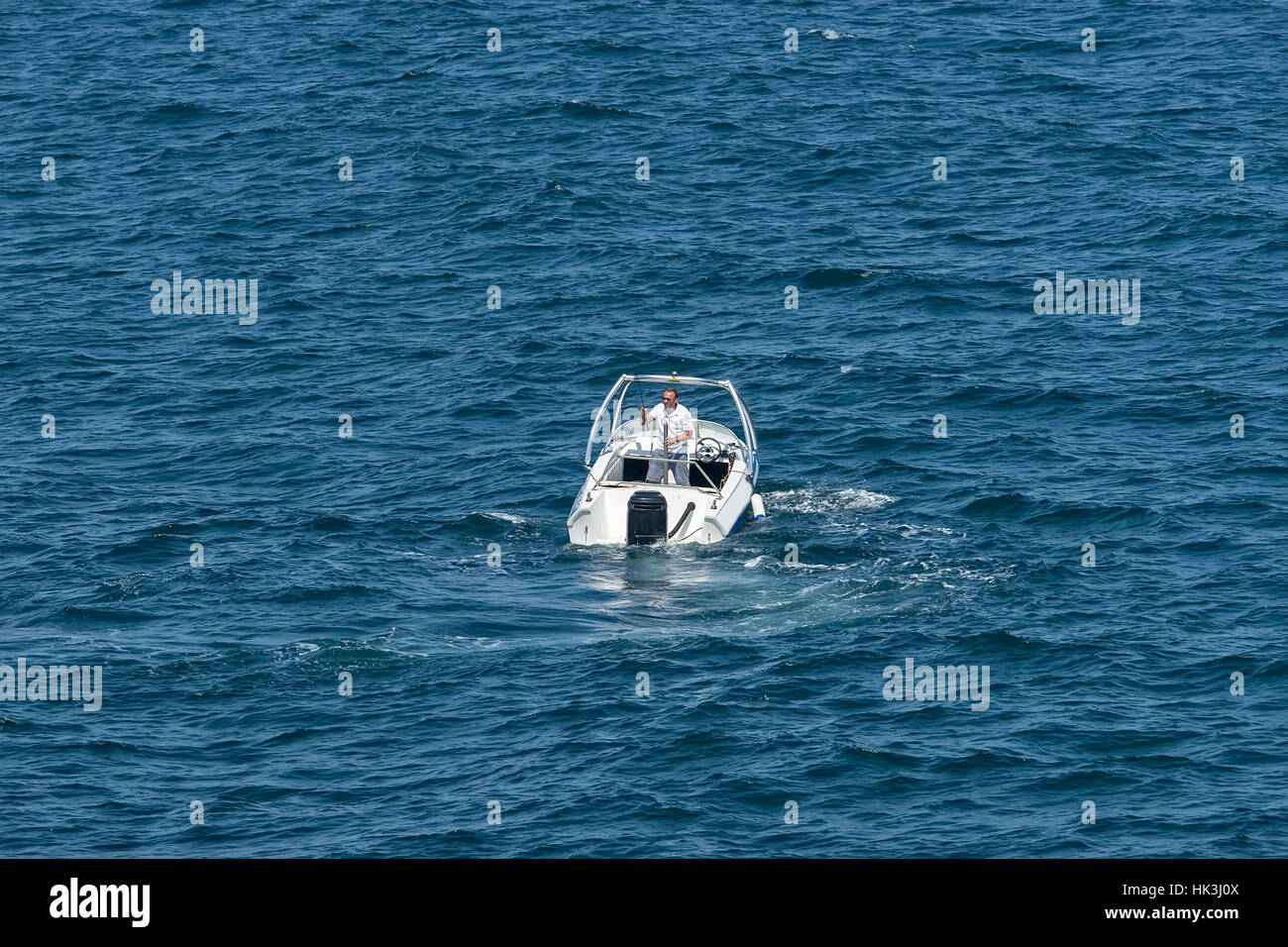 Primorsko, Bulgaria - September 09, 2016: Man fishing from a boat on the sea Stock Photo