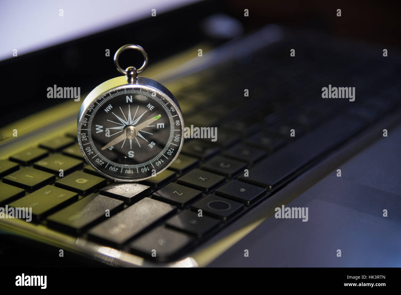 Compass shining on Keyboard metaphor to target or trend of business, marketing, finance, economy, internet concept background Stock Photo