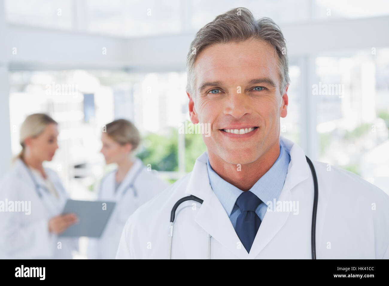 Cheerful grey haired doctor hi-res stock photography and images - Alamy