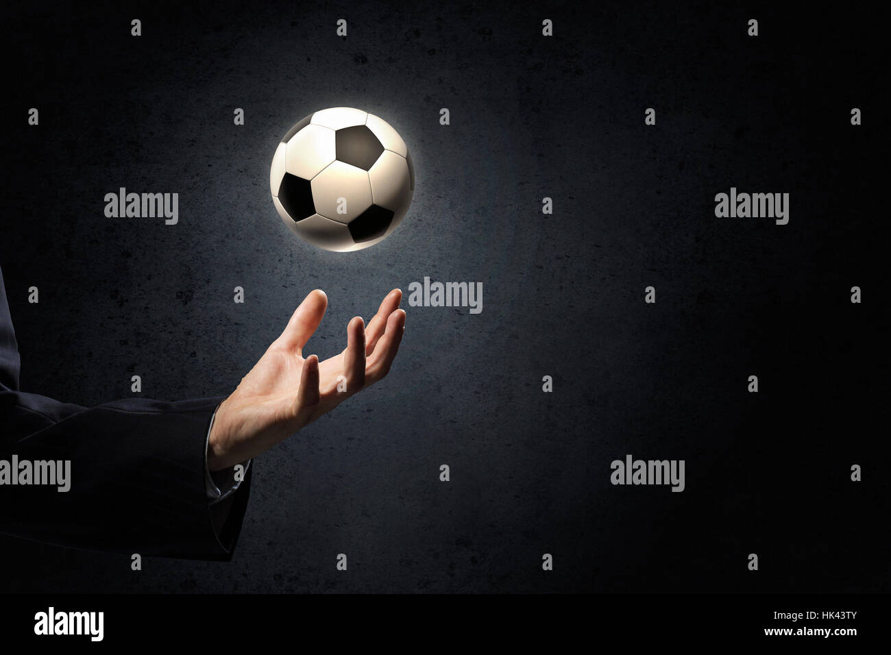 Close up of elegant businessman holding soccer ball in hand Stock Photo ...