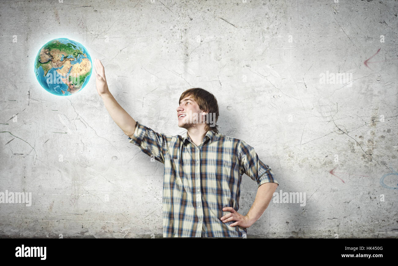 Young man touching image of Earth planet. Elements of this image are ...