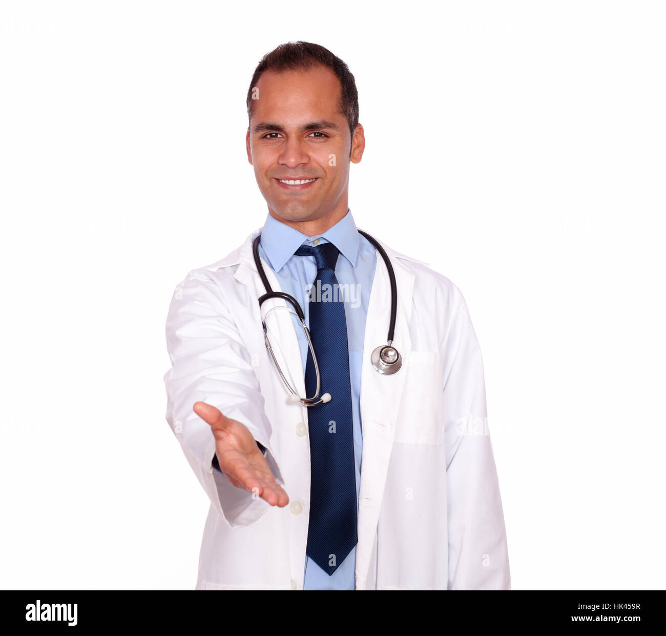 Portrait of an attractive medical doctor extending at you handshake standing in white uniform on isolated background Stock Photo