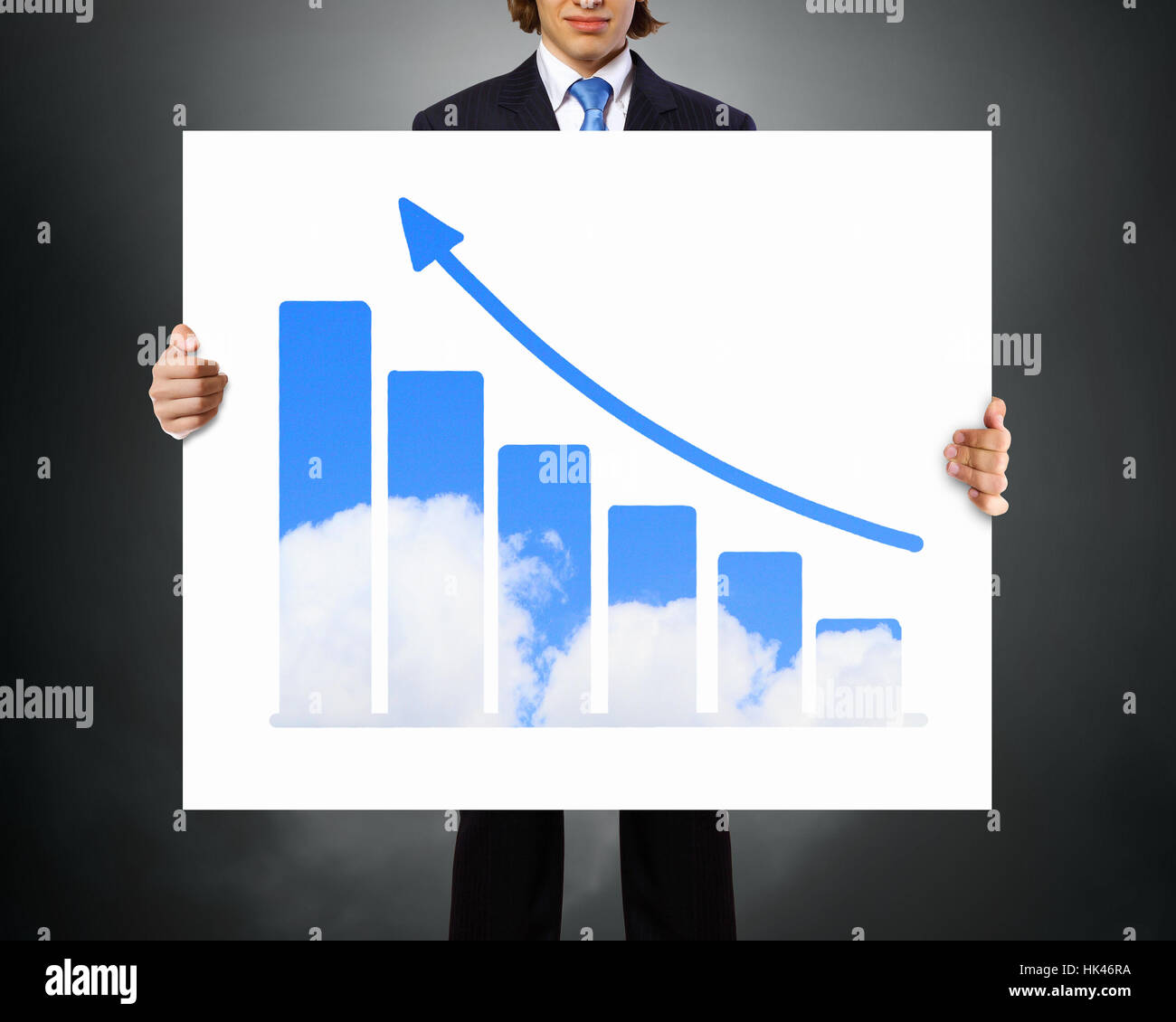 Businessman holding poster with growing arrow graph Stock Photo - Alamy