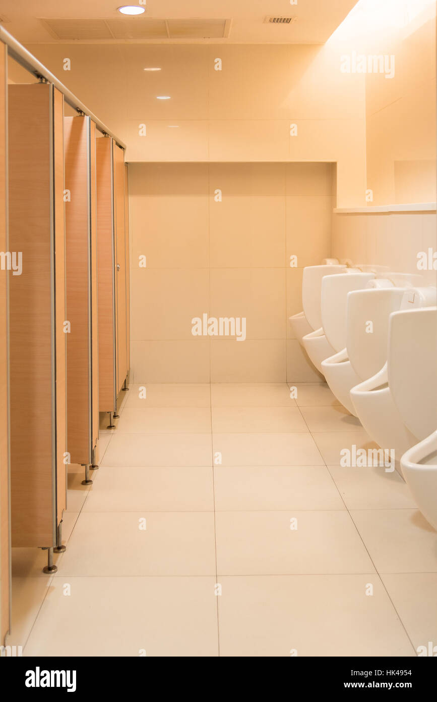 Public clean modern white male toilet, restroom with urinals, interior idea concept background Stock Photo