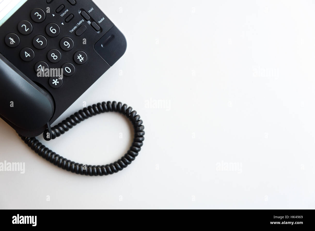 Top view or flat lay of digital voip black telephone on white table, call center, contact center, customer service, customer support concept backgroun Stock Photo