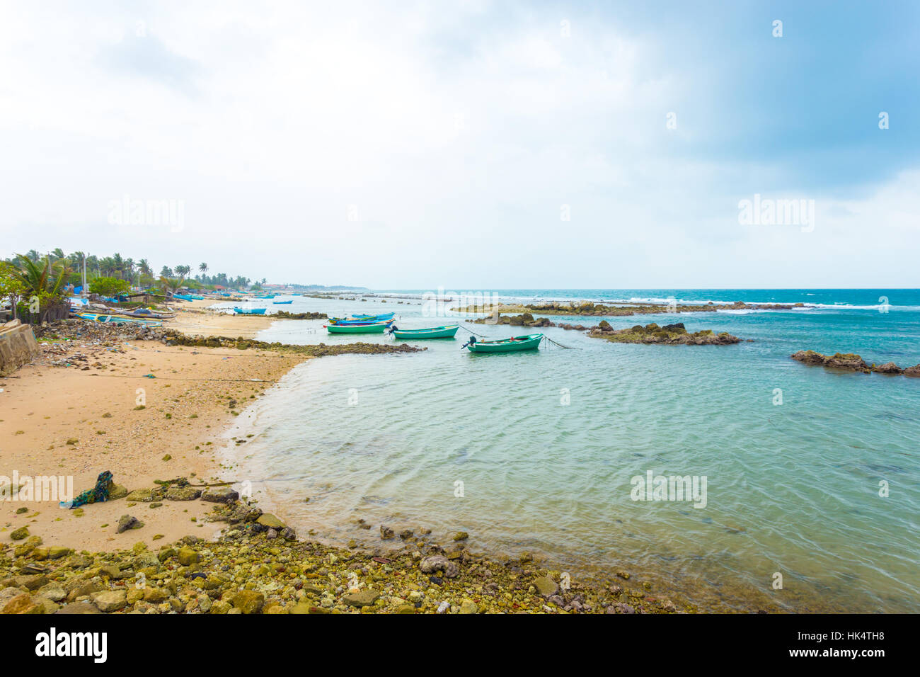 Fishing boats anchored outside a fishermen village in Point Pedro on a stormy day along the northern coast of Jaffna, Sri Lanka Stock Photo