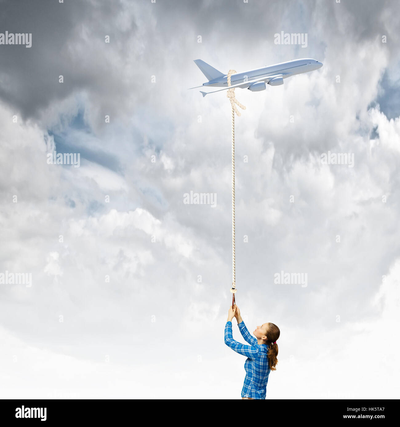 Invistable Flying Rope Young woman holding flying airplane with rope Stock Photo - Alamy