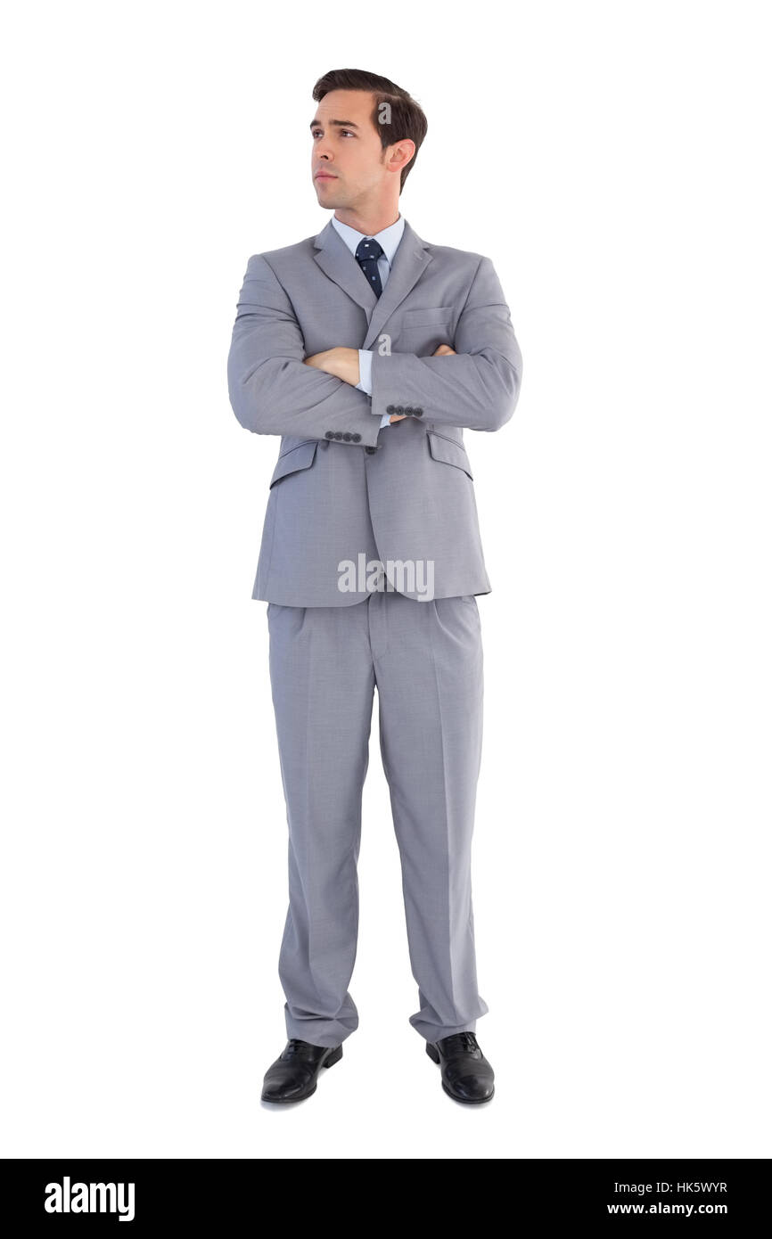 Serious businessman with arms crossed on white background Stock Photo ...