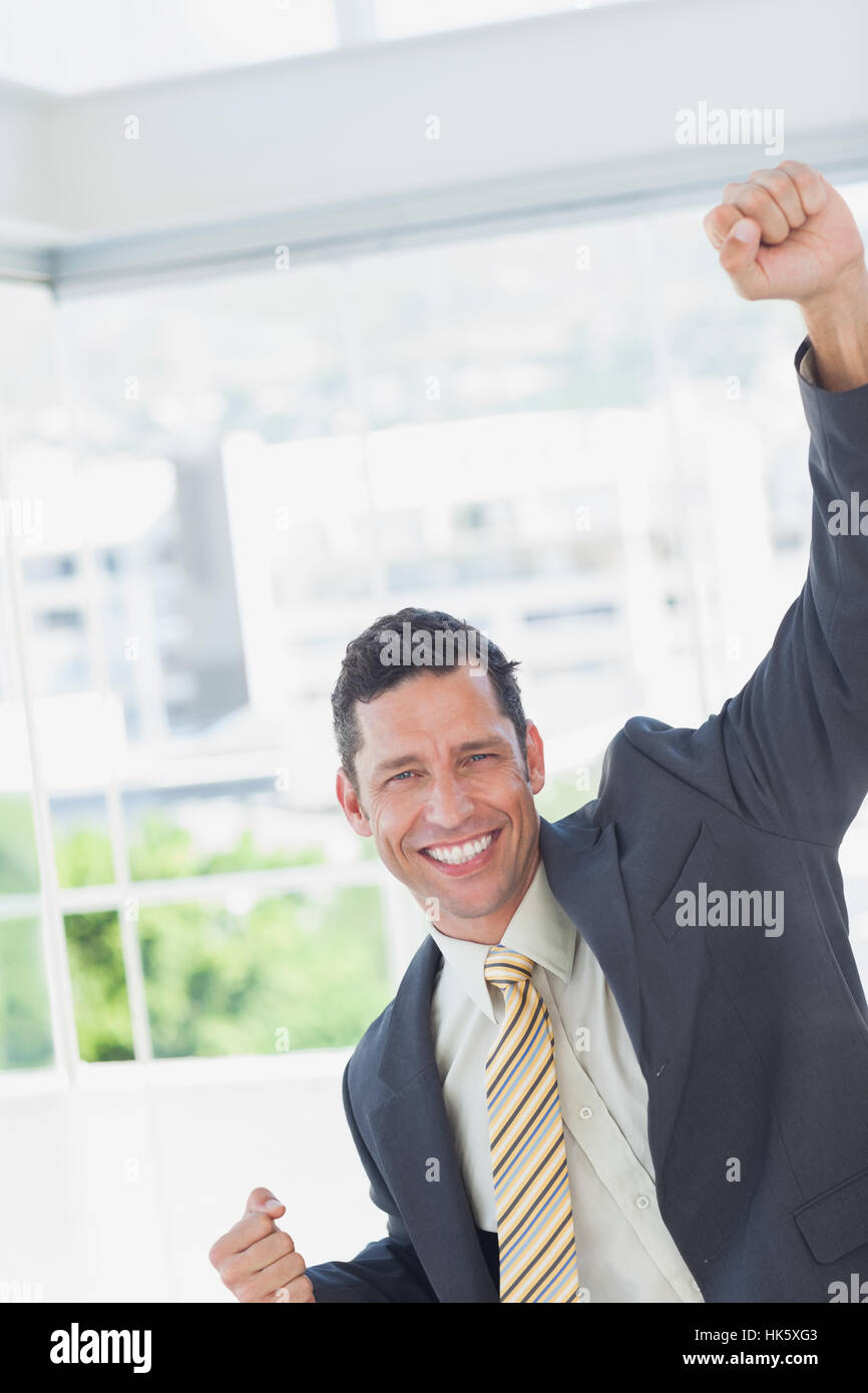Businessman cheering in office Stock Photo - Alamy