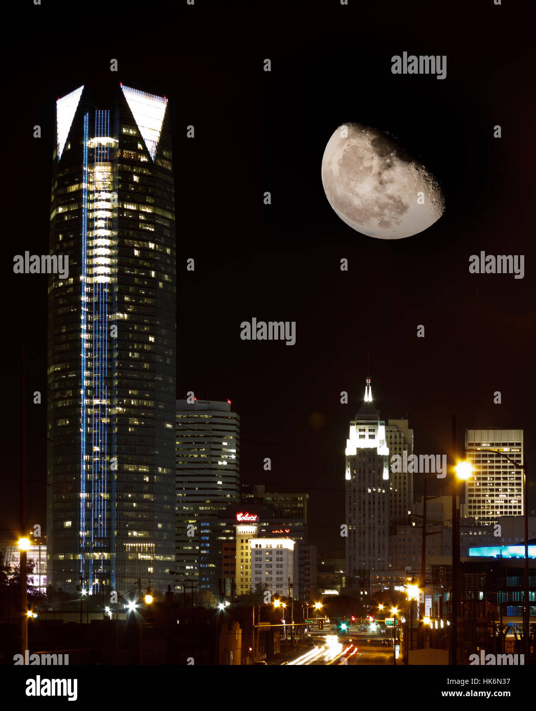 A view of downtown Oklahoma City at night with the moon above the city