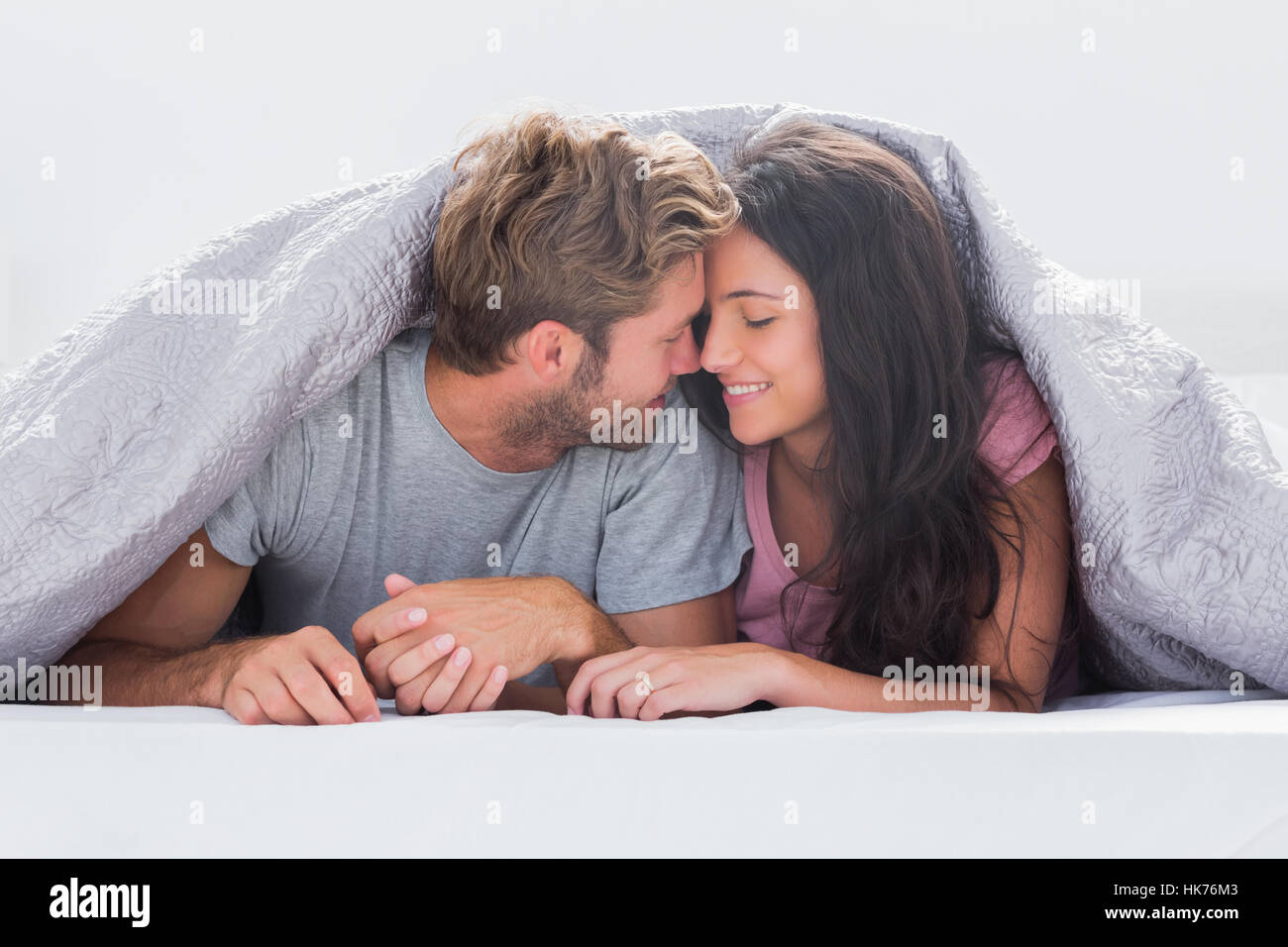 Couple in bed romance under hi-res stock photography and images