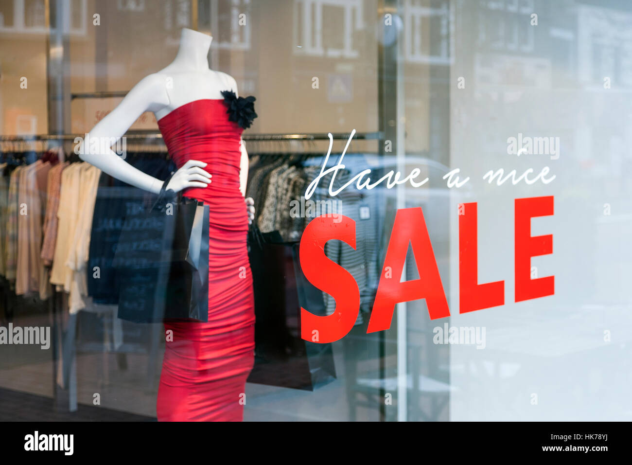 fashion doll with dress for women and the word sale on display window of clothing  store Stock Photo - Alamy