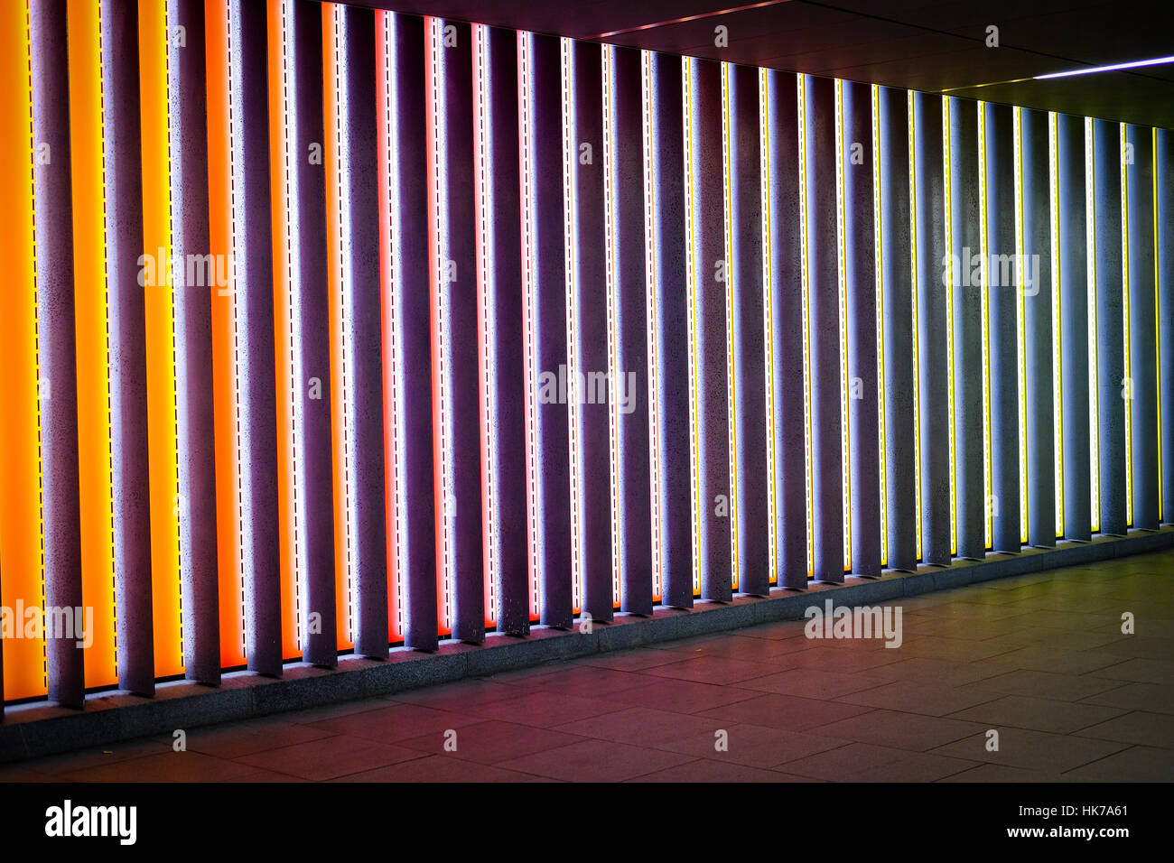 A lit, multicoloured urban underpass Stock Photo