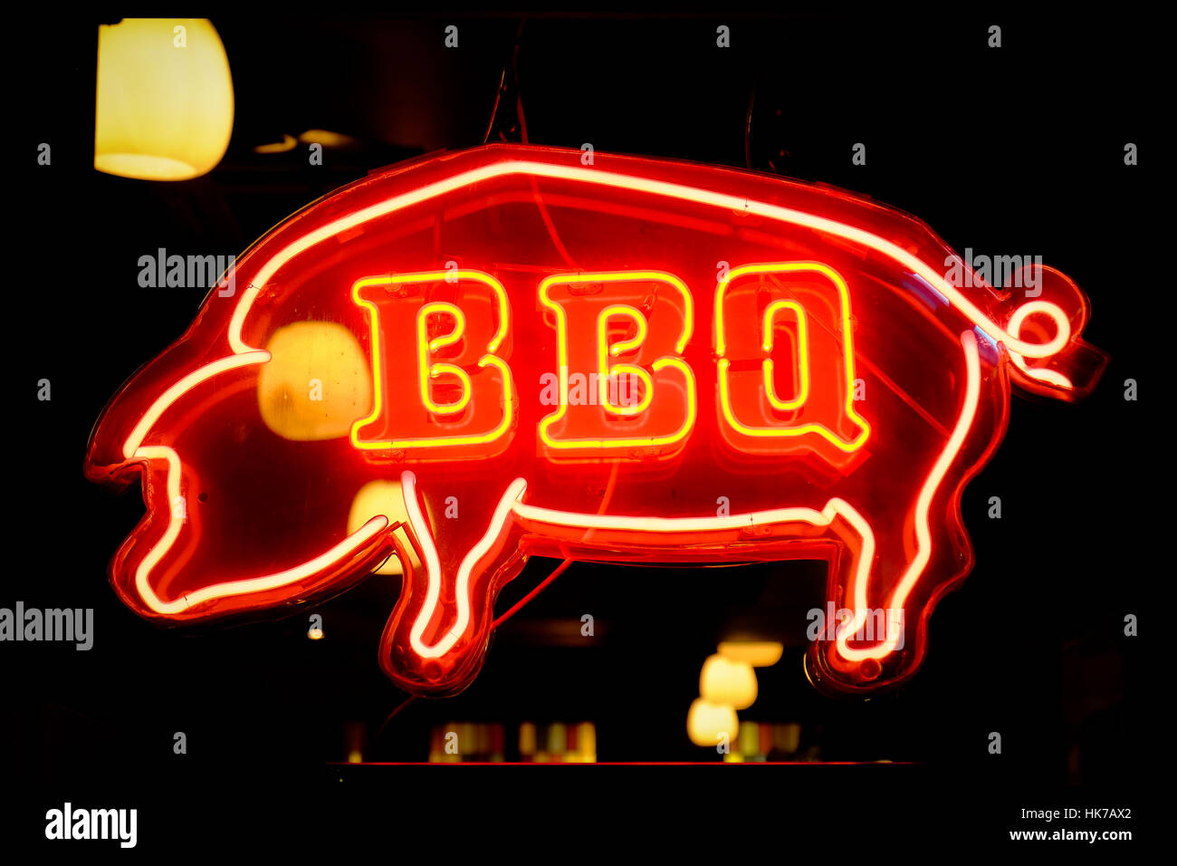 A neon sign advertises BBQ pork Stock Photo