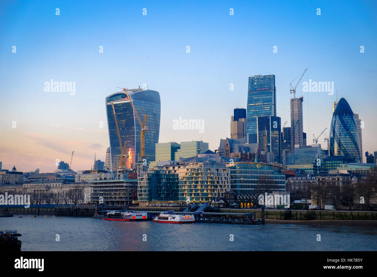 London's skyline at sunset with the River Thames in the foreground Stock Photo