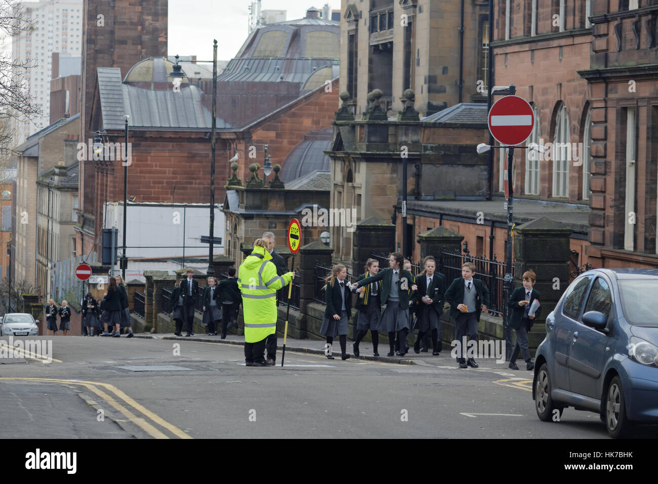 British school children from St Aloysius' College at lunch time eating junk food  returning to school Stock Photo