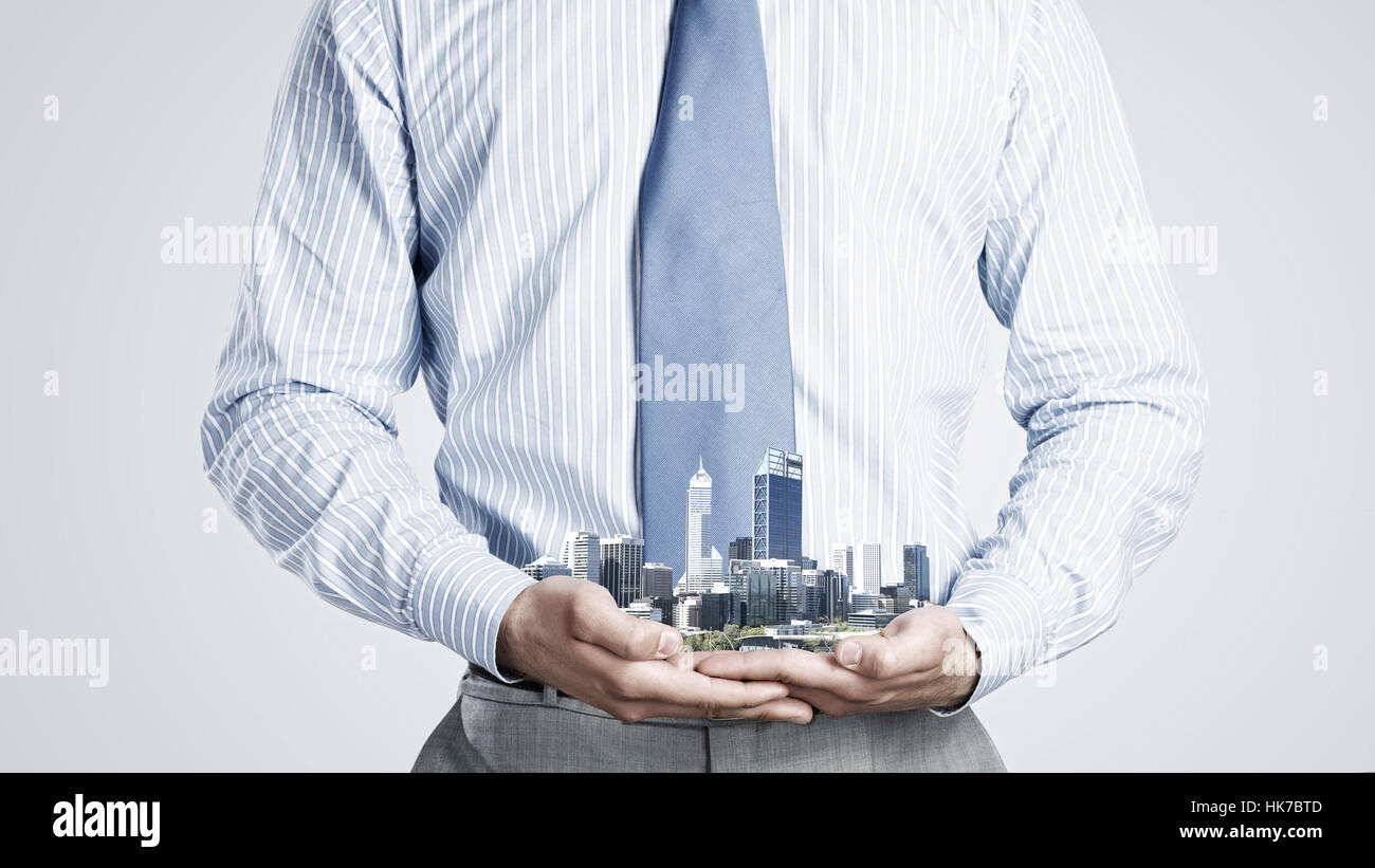 Close up of businessman holding in hands construction model Stock Photo ...