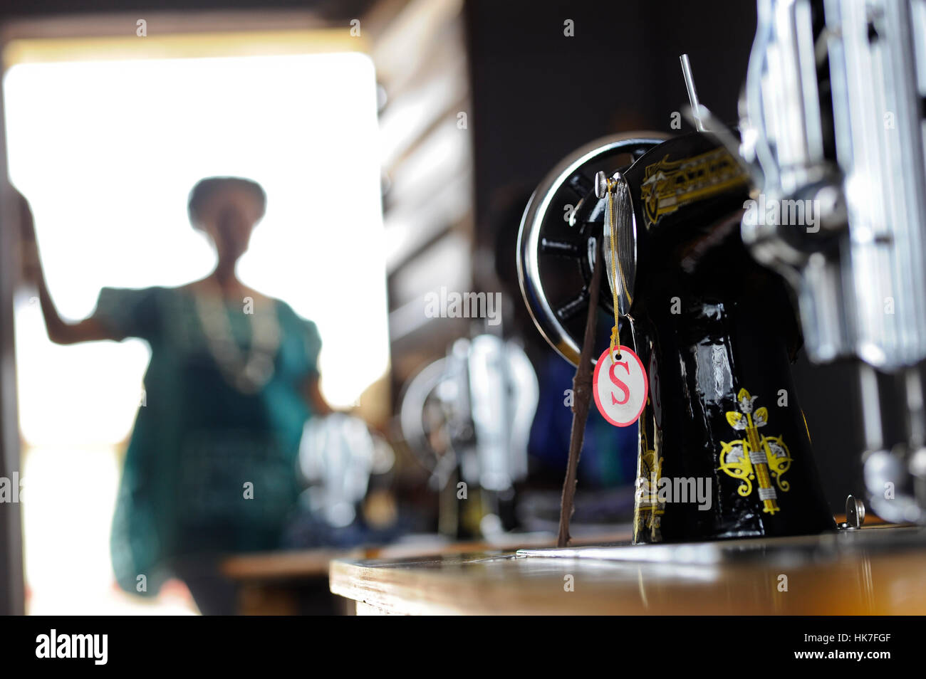 SIERRA LEONE, Waterloo, tailoring centre for women, sewing machine, woman standing in door, out of focus, blurred Stock Photo