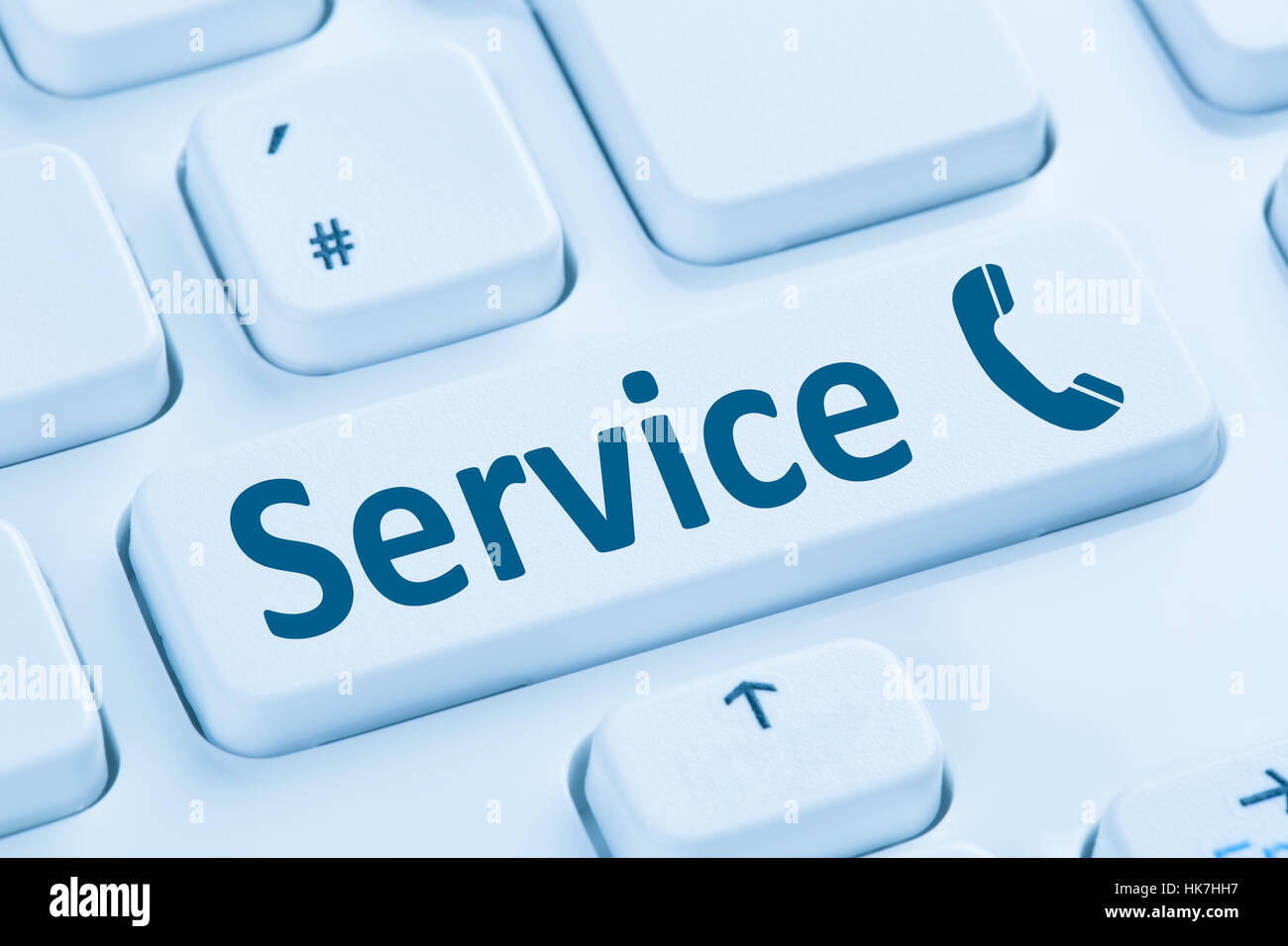 Service customer hotline telephone call calling symbol blue computer keyboard Stock Photo