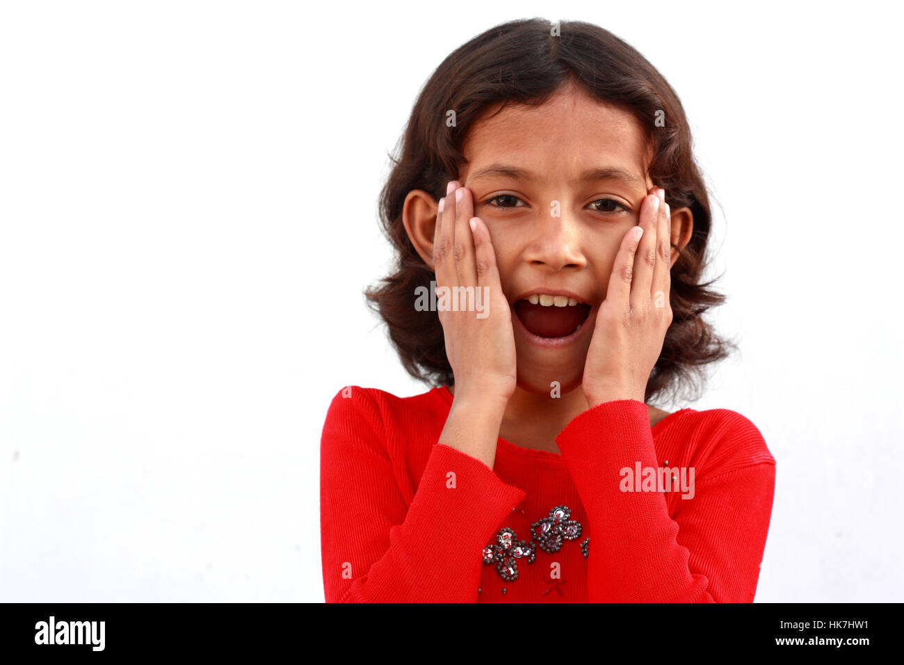 Little girl surprised with hands on her face Stock Photo - Alamy