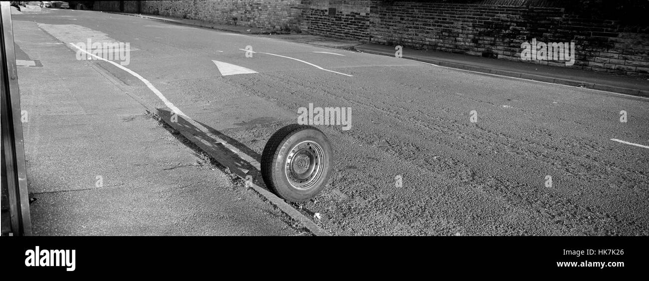 Car tyre at the corner of Ashwell Road and Whetley Lane, the dawn after the Bradford Riots.Manningham, Bradford UK. 8 July 2001.  The Bradford Riots w Stock Photo