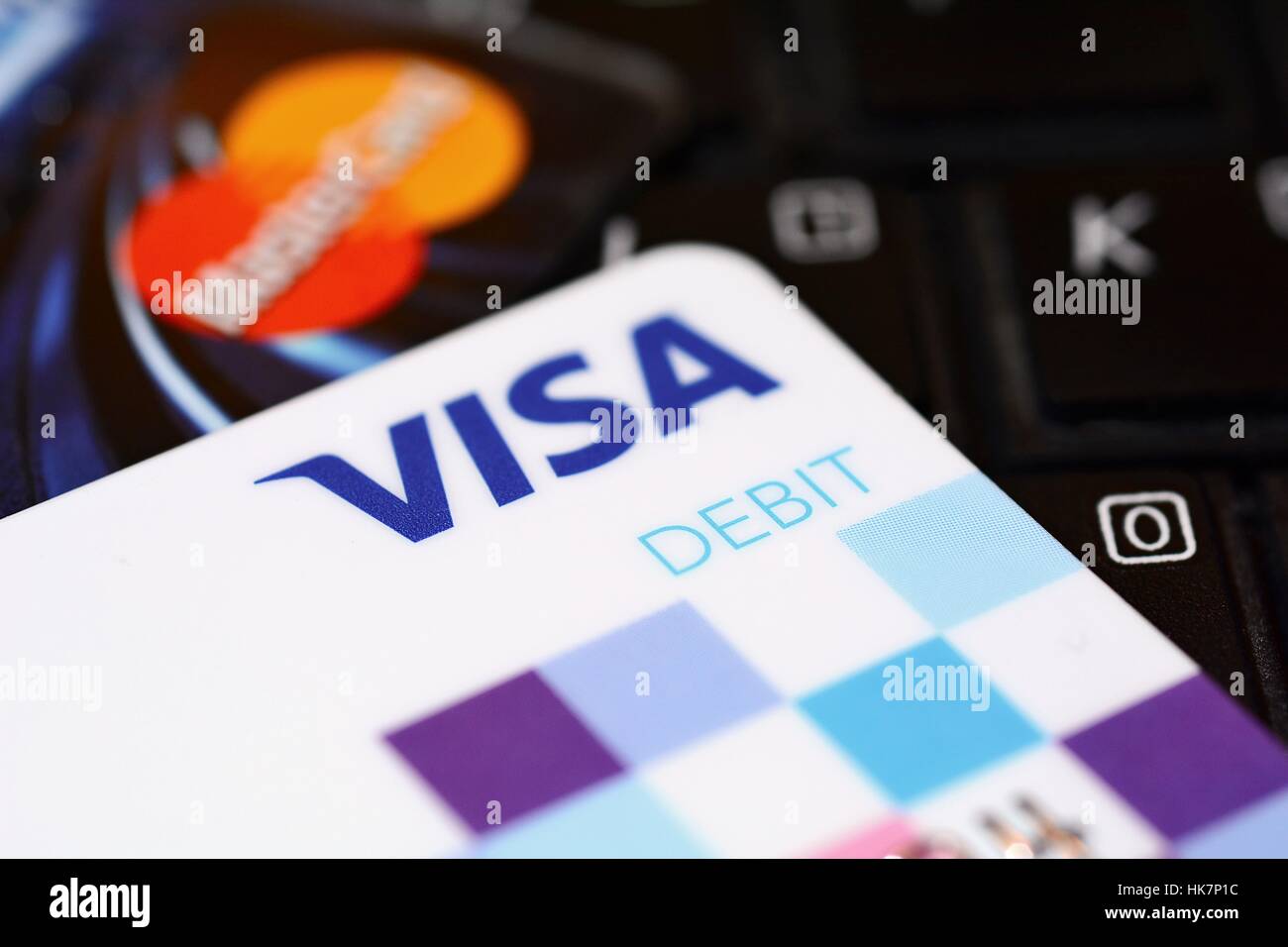 VISA and MasterCard payment debit cards put on black keyboard. Stock Photo