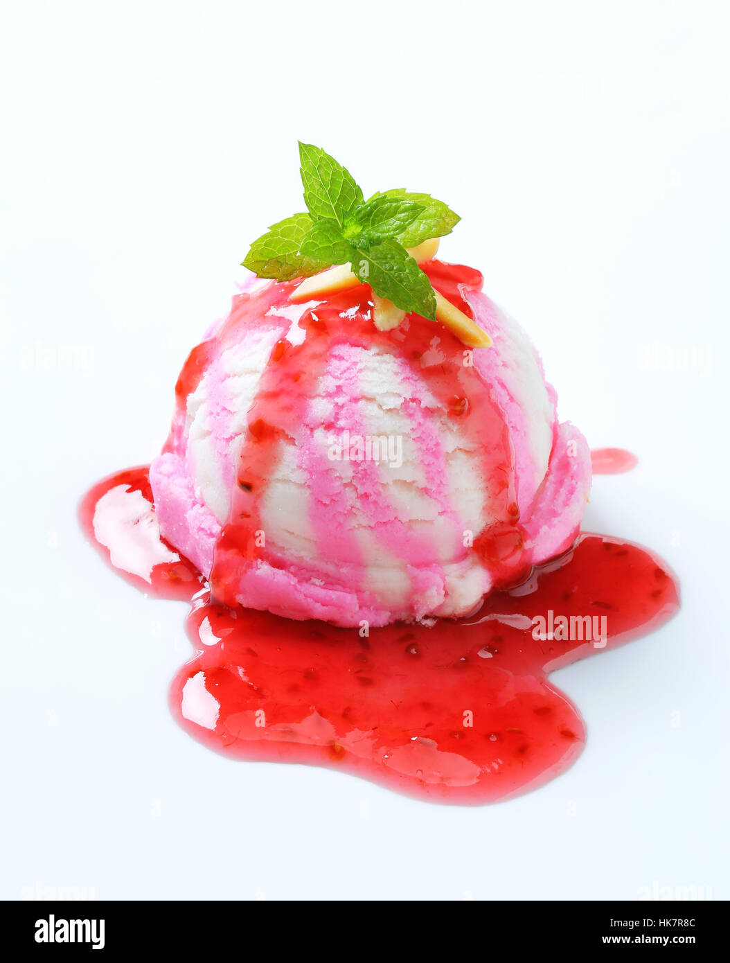 Scoop of raspberry ice cream with syrup Stock Photo - Alamy