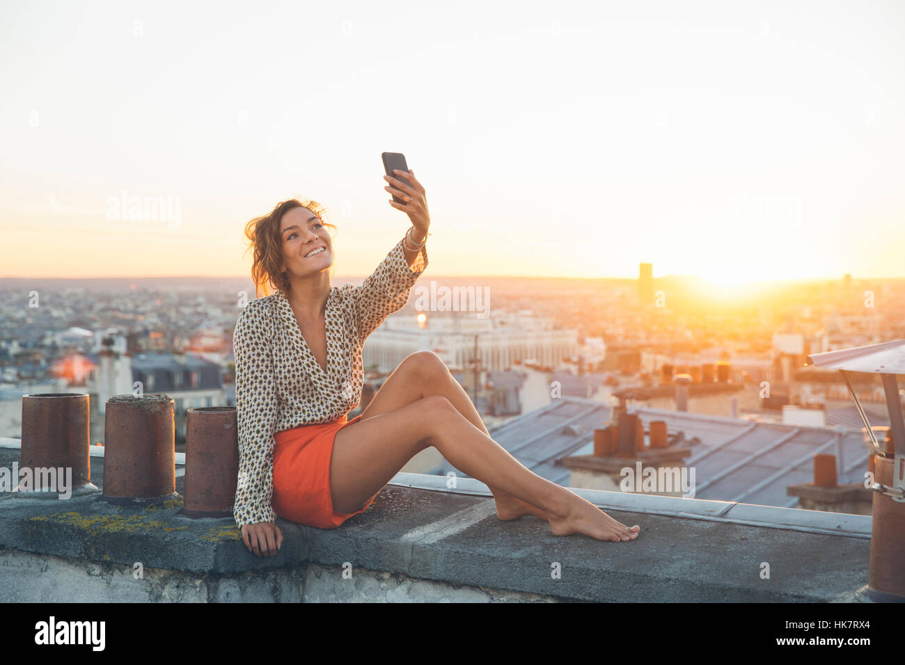 Woman doing a selfie on the roofs of Paris Stock Photo